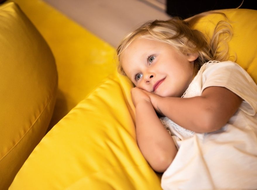 kid rests on bean bag