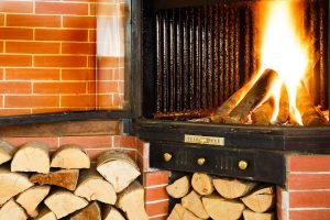 Wood burning fireplace and logs of wood